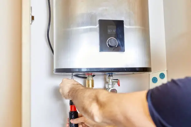 Expert repairs boiler unit during routine heating system maintenance inspection service.