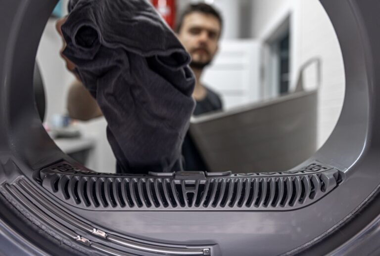 man holding-dirty-cloth-hand-view-inside-washing-machine_169016-12826