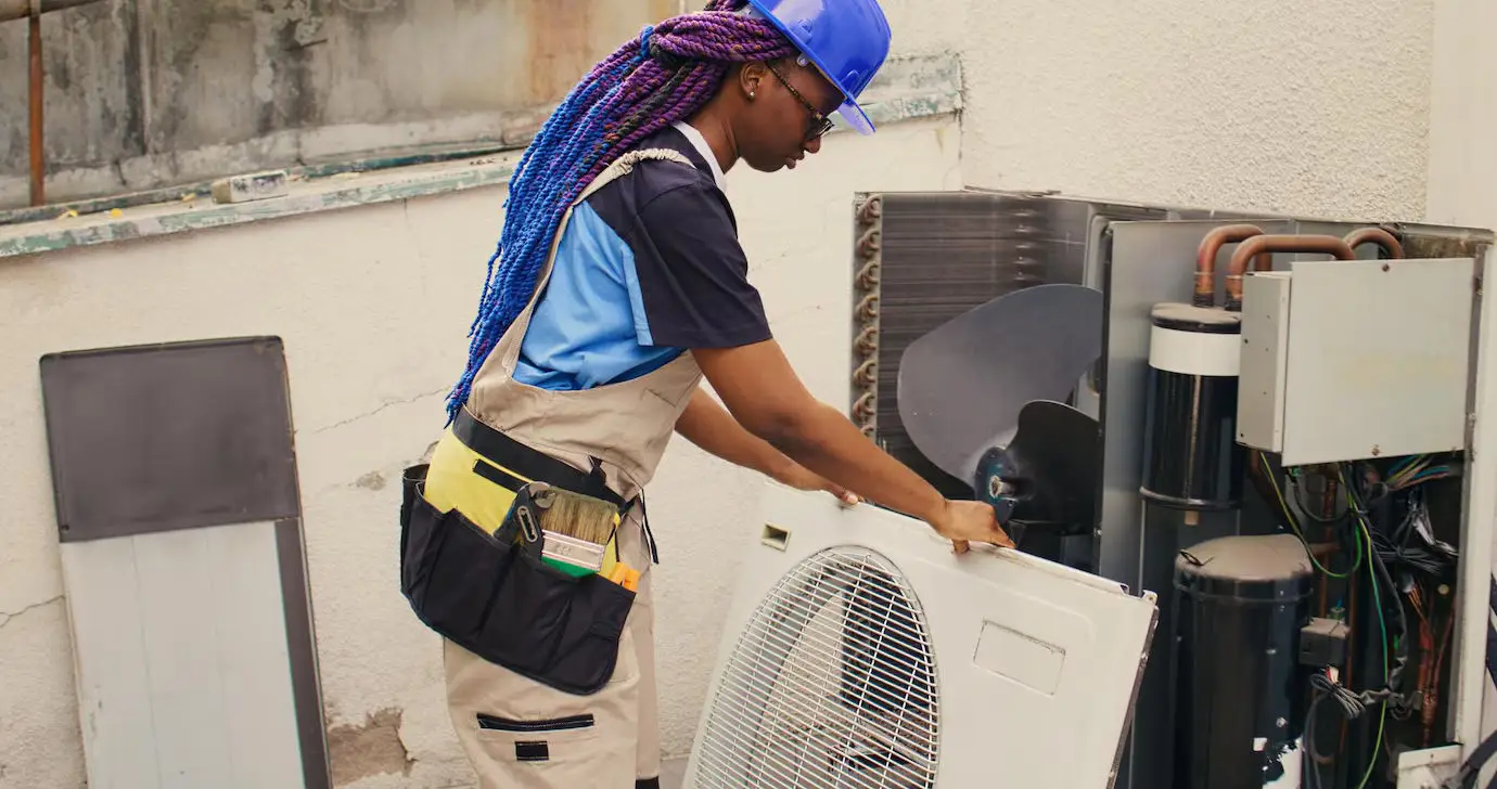 repairman working air conditioner